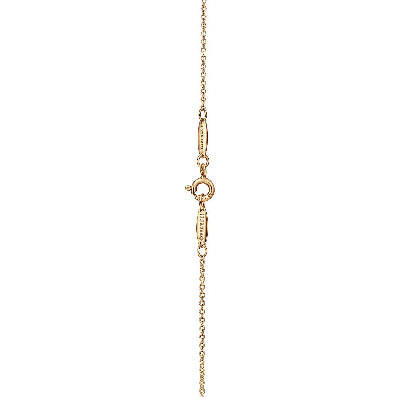 TIFFANY  ELSA PERETTI® OPEN HEART PENDANT IN YELLOW GOLD WITH RUBIES, 16 MM